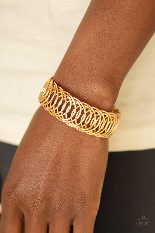 Dizzyingly Demure - Gold Flexible Cuff Bracelet - Paparazzi Accessories - GlaMarous Titi Jewels