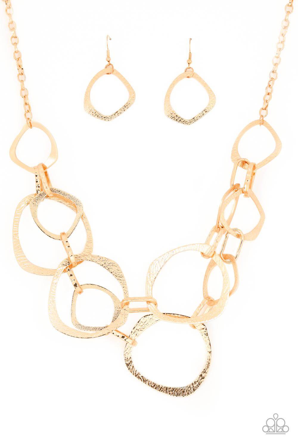 Salvage Yard - Gold Oversized Asymmetrical Rings Necklace - Paparazzi Accessories - GlaMarous Titi Jewels