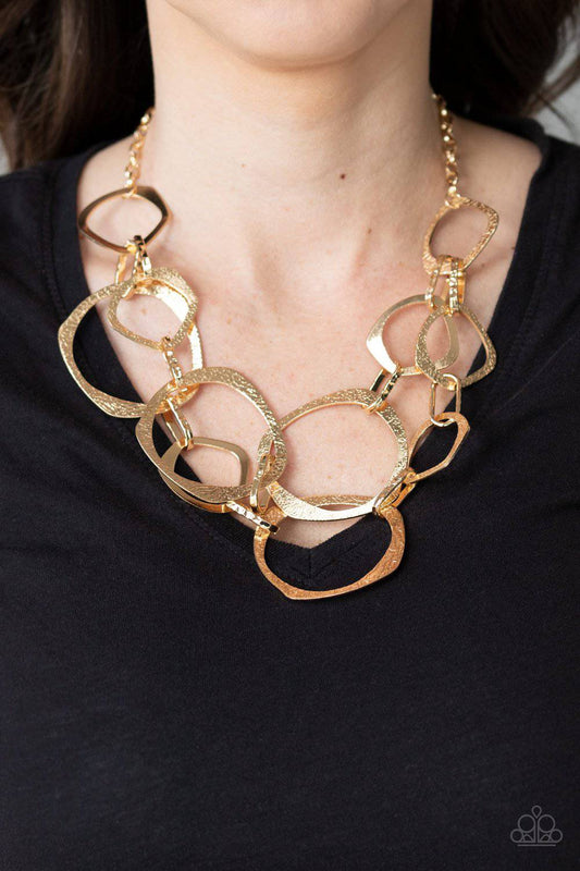 Salvage Yard - Gold Oversized Asymmetrical Rings Necklace - Paparazzi Accessories - GlaMarous Titi Jewels