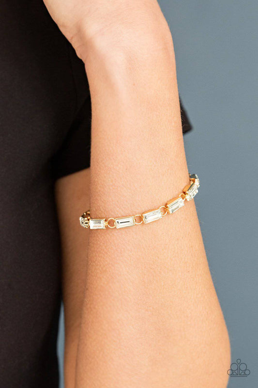 Irresistibly Icy - Gold and Rhinestone Bracelet - Paparazzi Accessories - GlaMarous Titi Jewels